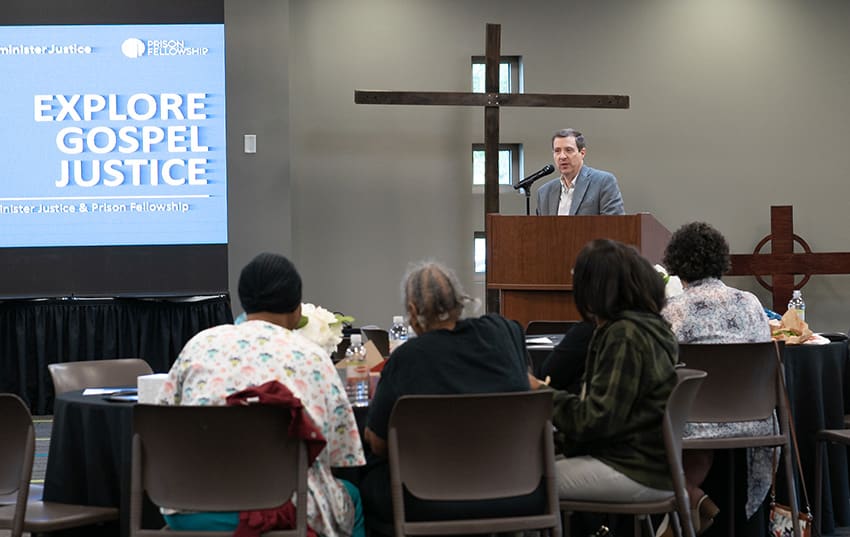 bruce speaking at event in atlanta