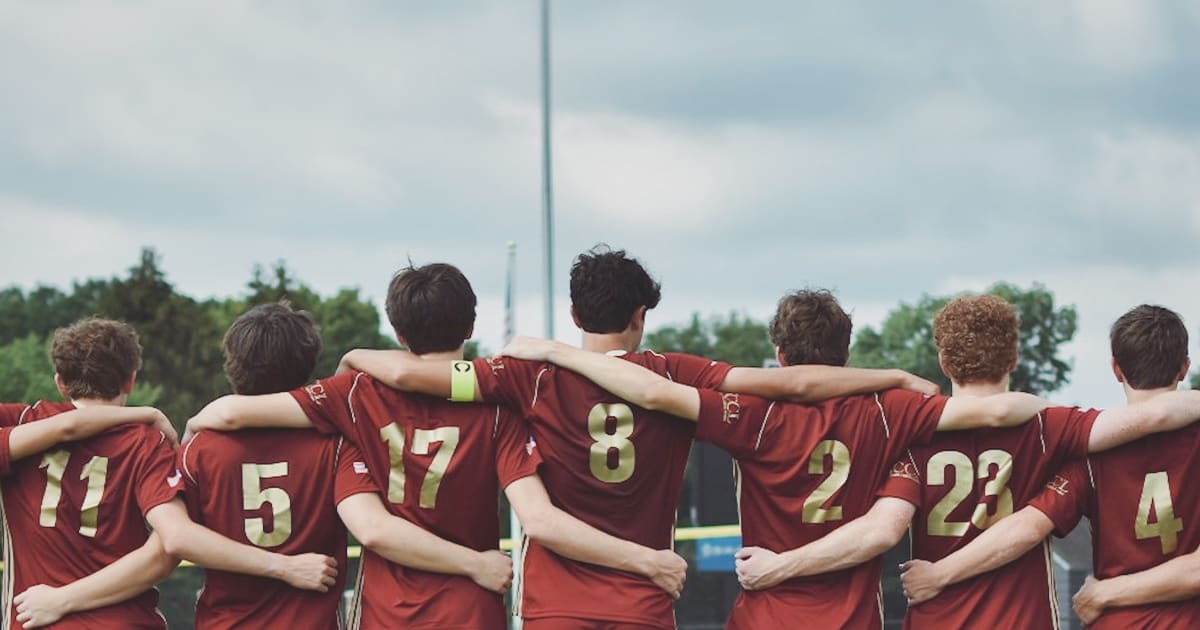 sports team with arms around each other