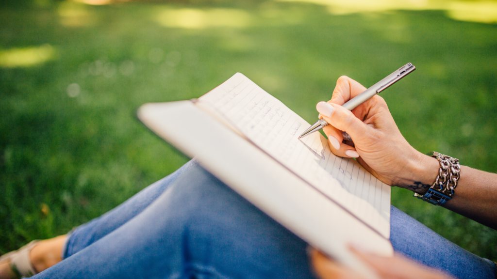 A woman writing down things she is grateful for.